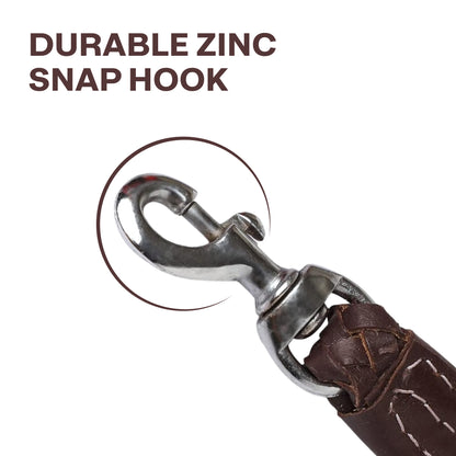 Close-up of a durable zinc snap hook on a brown leather leash with text 'DURABLE ZINC SNAP HOOK'.